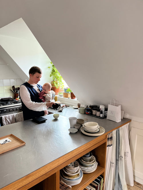 Woman holding a baby in the kitchen